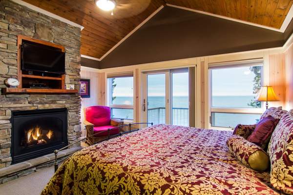 Cabin bedroom with fireplace on lake