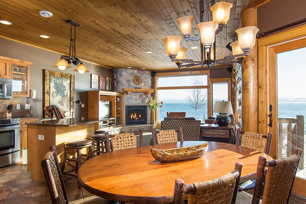 Cabin dining room with fireplace on lake